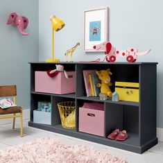 a child's room with toys and bookshelves