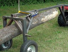 a large log is attached to a cart with wheels