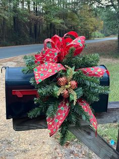 a mailbox decorated with red and green bows