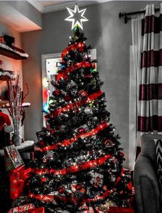 a black and red christmas tree in a living room