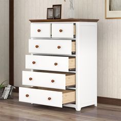 a white dresser with four drawers in a room