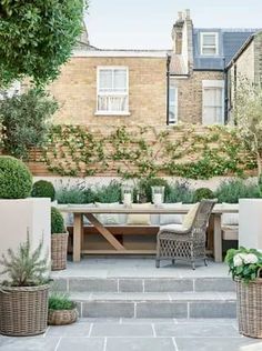 an outdoor dining area with potted plants