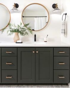 a bathroom with two round mirrors on the wall