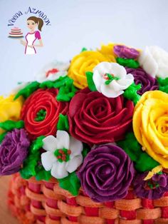 a basket filled with lots of colorful flowers on top of a table