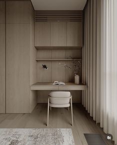 a desk and chair in a room with white curtains on the windowsill, along with a rug