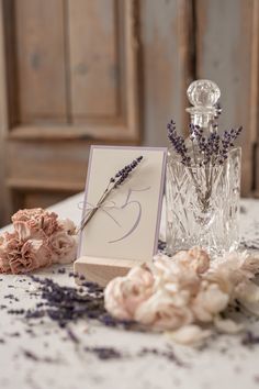 a table topped with flowers and a card