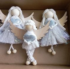 three little angel dolls in a cardboard box