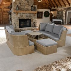 a living room filled with furniture and a fire place in the middle of an open floor plan