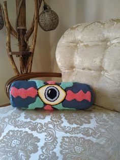 an eye pillow sitting on top of a bed