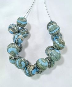 All products are handmade and unique. All beads are made by myself, in my own studio in Turkey-Selçuk-Şirince village. For my work i used Effetre (Moretti) - İtalian glass and the others. Shaped with breath.  Stainless steel wire, transparent silicone cord and nickel free clasp.  About 50 cm  long. If it falls on a hard surface, it may break. Do not wash with water. Wipe gently with a damp, soft cloth. The necklace is in an asymmetrical form.  The form does not deteriorate when you remove the br Artistic Handmade Beaded Necklaces With Round Beads, Handmade Artistic Beaded Necklaces, Artistic Handmade Jewelry With Round Beads, Handmade Artistic Jewelry With Round Beads, Artistic Handmade Round Bead Jewelry, Artsy Necklace With Unique Variations For Party, Artsy Necklaces For Parties, Artistic Beaded Necklace With Large Beads For Gifts, Handmade Czech Glass Round Pendant Necklace