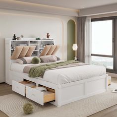 a white bed with drawers underneath it in a bedroom