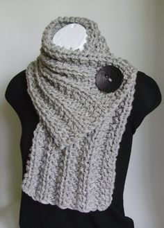 a gray knitted scarf on top of a mannequin