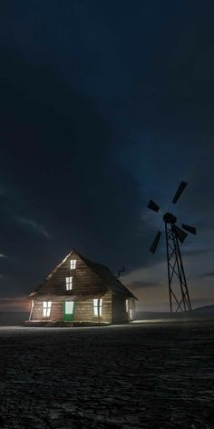 an old wooden house with windmills in the background at night, lit up by lights from windows