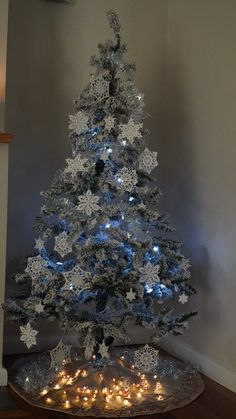 a white christmas tree with snowflakes on it