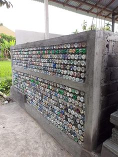 a wall made out of beer cans and concrete