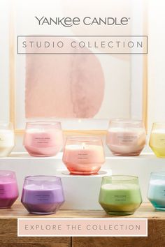 yankee candle's studio collection is displayed in front of a window with the words explore the collection