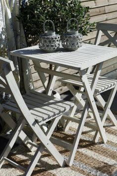 an outdoor table and chairs on a patio