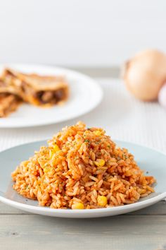 a white plate topped with rice next to an egg