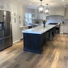 a large kitchen with an island in the middle