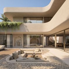 an outdoor living area with couches and tables