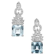 1950's Spectacular vintage mid-century aquamarine and diamond dangle earrings. 2 square cut aquamarine gemstones totaling 8.66cts set in platinum four prong settings. Accented with 1.32cts if marquise, round brilliant cut and single cut diamonds in a radiating sunburst pattern. The aqua's are a beautiful rich yet vibrant blue color and with the varying shapes and sizes of the diamonds, truly makes this a unique vintage piece. 2 square cut blue aquas, approx. 8.66cts 2 marquise diamonds, I-J SI2 approx. .77cts 2 round brilliant cut diamonds, SI -H approx. .20cts 26 single cut diamonds, H-I VS SI approx. .35cts Platinum Length: 1.30in or 32.78mm Stamped: PLAT 9.74 grams Please Note, we photograph each item as accurately as possible. However due to monitor/mobile device resolution and calibra Luxury Aquamarine Fine Jewelry, Luxury Aquamarine Exquisite Jewelry, Luxury Aquamarine Brilliant Cut Jewelry, Luxury Blue Aquamarine Earrings, Yoke Pattern, Luxury Aquamarine Gemstone Earrings, Sunburst Pattern, Short Sweater, 1st Dibs