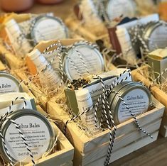 several small wooden boxes filled with different types of soaps