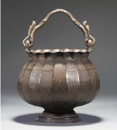 an old fashioned metal pot with handles