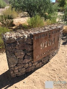 a sign that is on the side of a dirt road