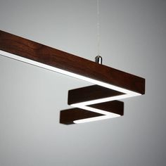 a wooden light fixture hanging from a ceiling