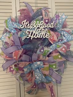 a purple and blue wreath with words on it