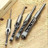 four different types of router bits on a wooden table with holes in the middle