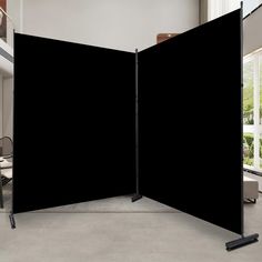 an open black screen in the middle of a room