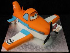 an orange and white airplane cake on top of a table