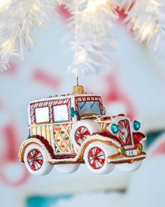 an ornament hanging from a christmas tree with a truck on it's side