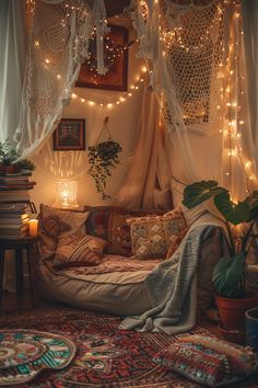 a bed with lights hanging from the ceiling and pillows on the floor next to it