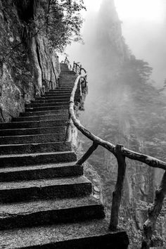 black and white photo of stairs leading up to the top of a mountain