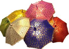 several different colored umbrellas sitting side by side on a white surface with one open and the other closed