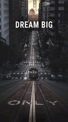 a poster with the words dream big in front of an image of a city street