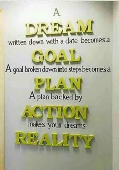 a sign on the wall that says dream goal plan action makes your dreams realty