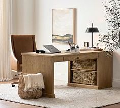 a wooden desk with two drawers and a laptop on it in a white living room