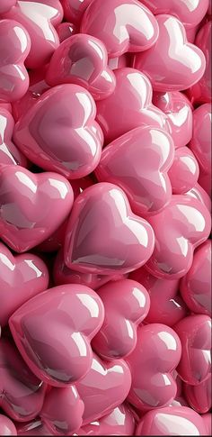 a pile of pink heart shaped balloons in the shape of hearts