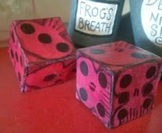 three pink and black dices sitting on top of a red table next to each other