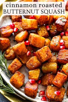 cinnamon roasted butternut squash with pomegranate and rosemary on a white plate