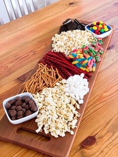 a wooden cutting board topped with lots of candy