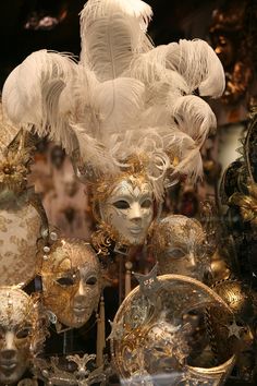 an assortment of masquerades and masks on display