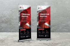 two roll - up banners with the words digital creative on them in front of a concrete wall