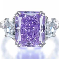 Stun In This Purple Lab Diamond Ring From Our Shop, Camila & Katie! This Ring Features: -Lab-Diamond Hybrid. -Radiant Cut Diamond. - 6,79 Carat Centerpiece.(10x12mm) -Beautiful Lab Man Made Diamond. -925 Sterling Silver Material Throughout. -Sparkles To The Max! Glitters, Shimmers, And Shines Like A Real Diamond. -Casual Yet Formal Style For Everyday Wearing! Luxury Purple Ring As Gift, Luxury Purple Ring For Gift, Luxury Purple Rings For Gift, Luxury Purple Ring As A Gift, Luxury Purple Promise Ring, Elegant Three Stone Amethyst Ring As Gift, Elegant Three Stone Amethyst Ring For Gift, Luxury Purple Diamond Ring As Gift, Luxury Purple Diamond Ring For Gift