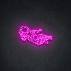 a neon sign that is on the side of a wall in front of a black background