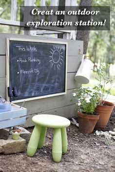 a chalkboard with writing on it next to some potted plants and small stools