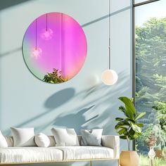 a living room filled with furniture and a large round mirror hanging on the wall above it